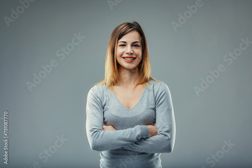 Woman stands firm, arms crossed, confidence radiating