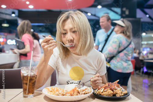 Woman holding a spoon and fork in her hand to eat the food on the plate photo
