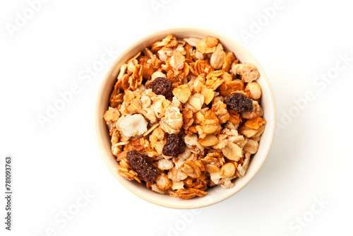Muesli oat cereals with raisins, dried fruits and sunflower seeds in bowl on white background. Top view