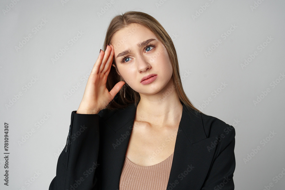 Woman Posing With Hands on Face against gray background Woman Posing With Hands on Face against gray background