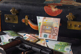 close up of colt 1911, ammos and money, suitcase on background