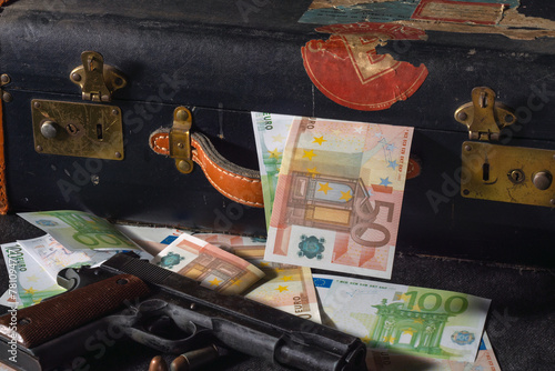 close up of colt 1911, ammos and money, suitcase on background © Philipimage