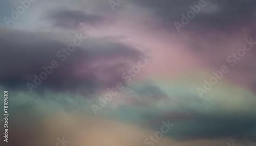 colorful watercolor background of abstract sunset sky with puffy clouds in bright rainbow colors of pink green blue yellow and purple
