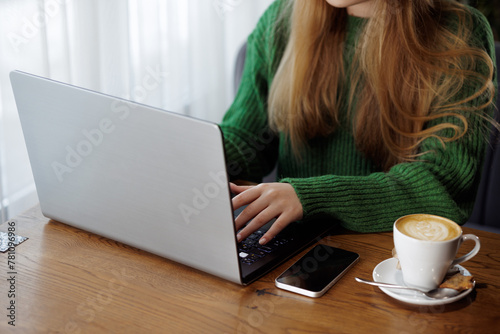 girl works online with laptop and drinks coffee, online orders