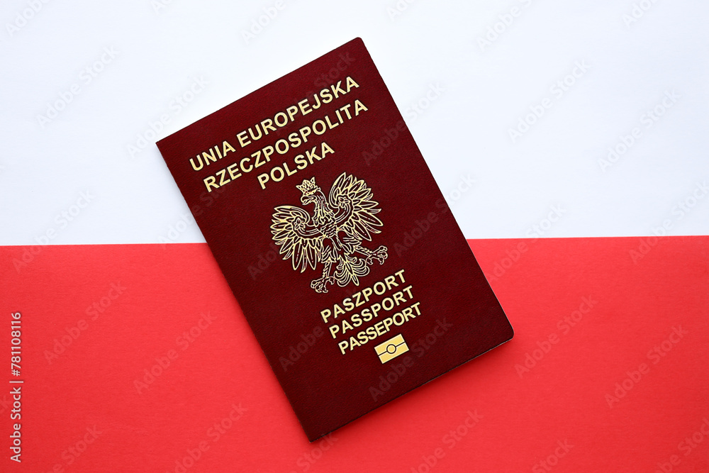 Red polish passport on smooth red and white flag of Poland close up Red polish passport on smooth red and white flag of Poland close up