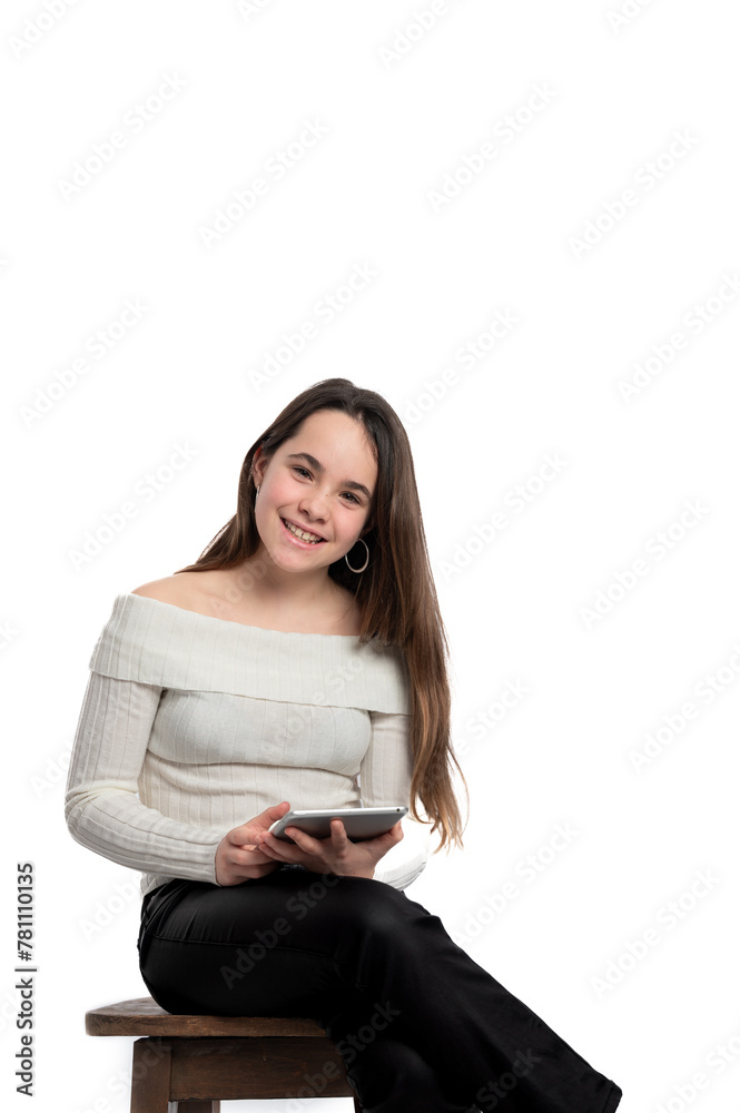 A woman is sitting on a wooden stool and holding a tablet A woman is sitting on a wooden stool and holding a tablet