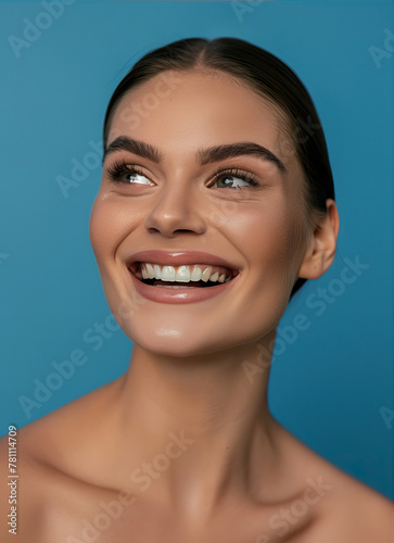 Portrait of a beautiful, smiling woman on a blue background 
