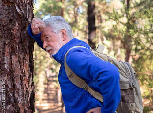 Obraz na plátně An active senior man with backpack breathless on a day hike in a mountain forest