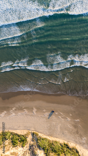 Rugged and beautiful beach, the west coast of New Zealands Northland.  Ripiro beach, holidays, travel and vacation.  Waves and sand. photo