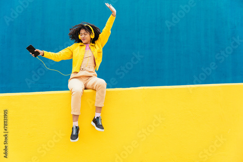 Young happy woman dancing and having fun outdoor