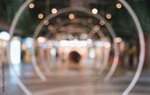 Blurred image of shopping mall with circle tunnel bokeh lights for background usage.