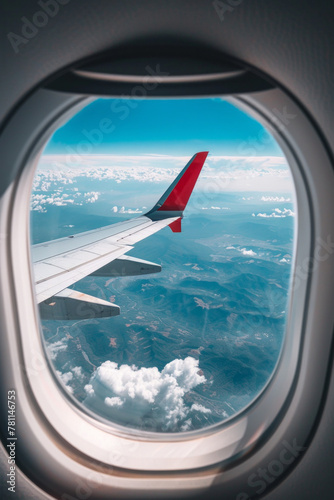 Landscape view with the flight wing from an airplane through window seat