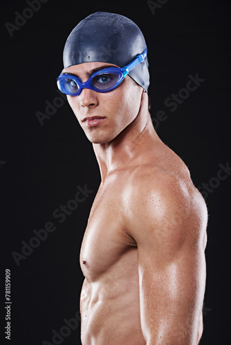 Male, swimmer and face with goggles and cap for fitness, sport or exercise isolated in portrait. Serious, man and athlete with swimming training or cardio practice for competition on black background