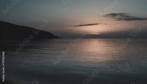 a serene seascape with the soft hues of the setting sun reflecting off the calm crystal clear waters