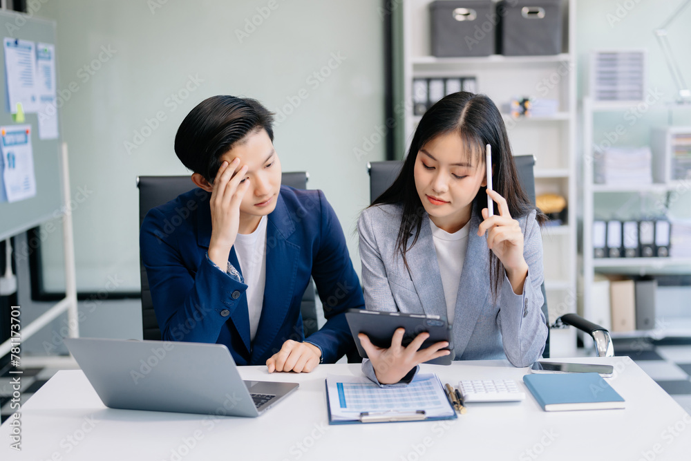 Furious two Asian businesspeople arguing strongly after making a mistake at work in office. Furious two Asian businesspeople arguing strongly after making a mistake at work in office.