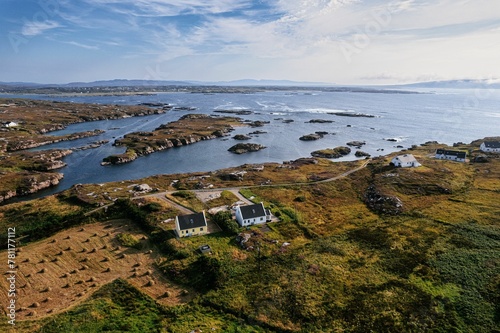 Aerial view of farmlands in the coastal area of Donegal before a blue skyline photo