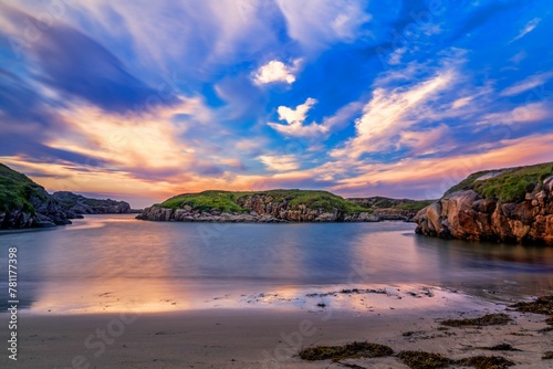 Long exposure view of water waves and coastal cliffs at sunset in Donegal