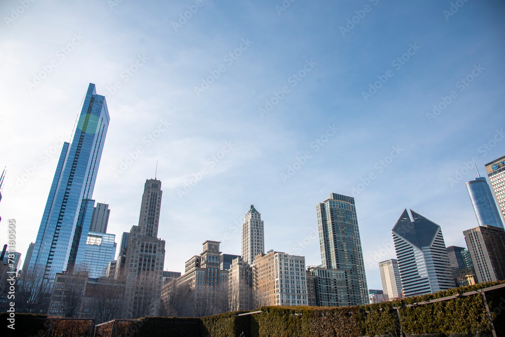 Fototapeta premium Modern glassy high-rise buildings and skyscrapers against a cloudy sky in Chicago