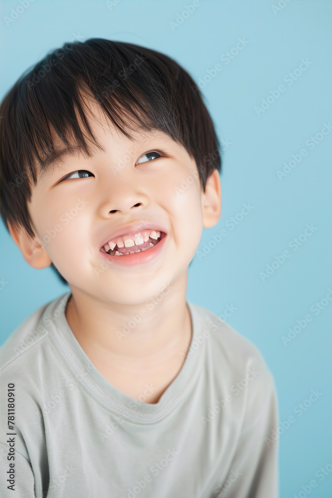Little boy smiling on blue background
Little boy smiling on blue background