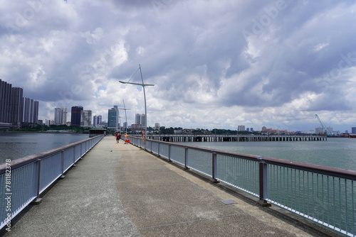 Walking bridge in the background of a cityscape on a cloudy day
