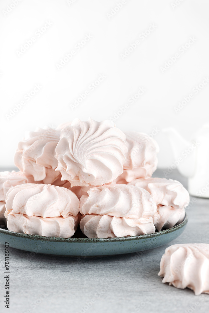 Russian sweet dessert - pink marshmallow zephyr on gray background. Meringue, souffle dessert. Copy space.