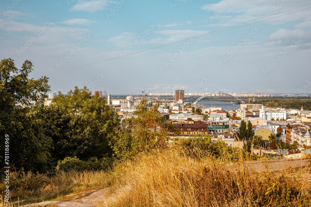 Cityscape of Kyiv with the Podilskyi bridge in the background on a sunny day