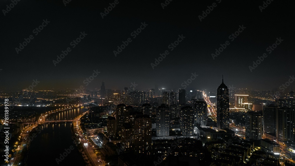 Beautiful  view of a modern city at night with the car and building lights illuminating the darkness