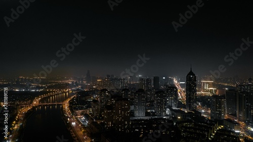 Beautiful view of a modern city at night with the car and building lights illuminating the darkness