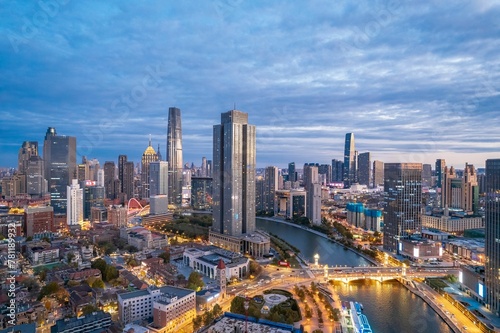 Aerial view of the Haihe River and the modern skyscrapers under the cloudy sky in Tianjin China © Wirestock