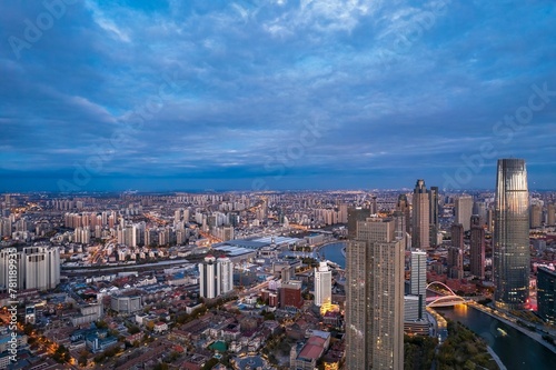 Aerial view of the Haihe River and the modern skyscrapers under the cloudy sky in Tianjin China