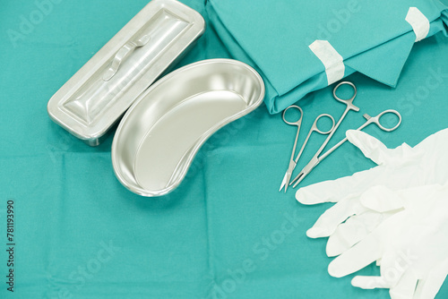 Surgical set and medical equipment on green surgical tray inside operating room.Sterile surgical instrument tool equipment for surgery.Infection control.