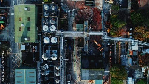 Aerial top view footage of a cran and other equipment working in an industrial area of factories photo