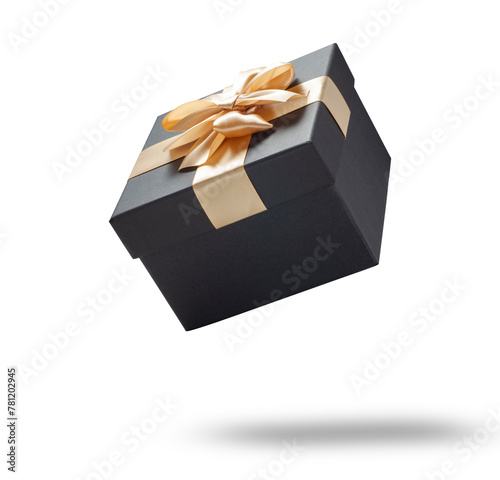 Black gift box with champagne gold ribbon bow isolated on white background