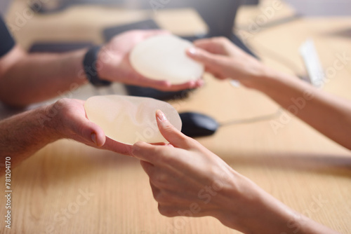 Doctor offers breast augmentation implants to a woman