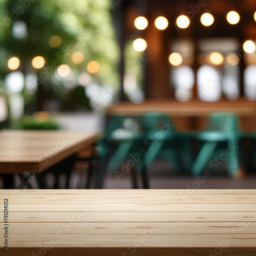 Empty wooden tabletop on blurred cafe background. Layout for design.
