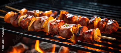 Grilled skewers with meat and vegetables cooking on BBQ grill