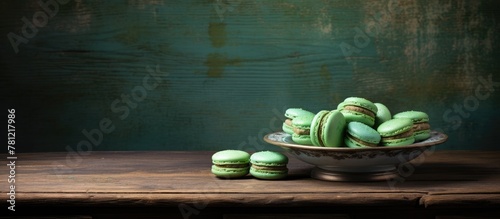 Green macarons in bowl on t...
