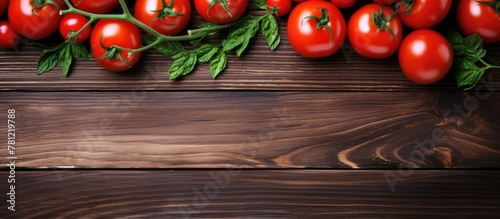 Fresh tomatoes green leaves wooden table