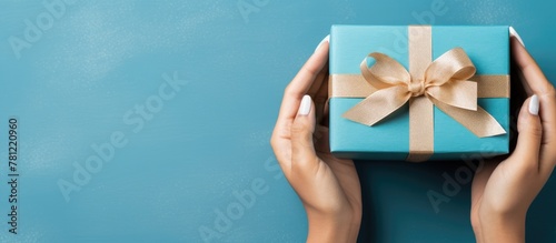 Woman holding blue gift box...