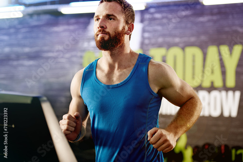 Gym, serious and man with running on treadmill for exercise, endurance workout and cardio health. Male person, athlete and training with machine for energy, body wellness and speed at fitness centre © peopleimages.com