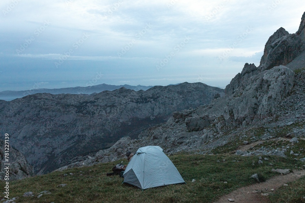 Tent with a view of rocky mountains in the evening