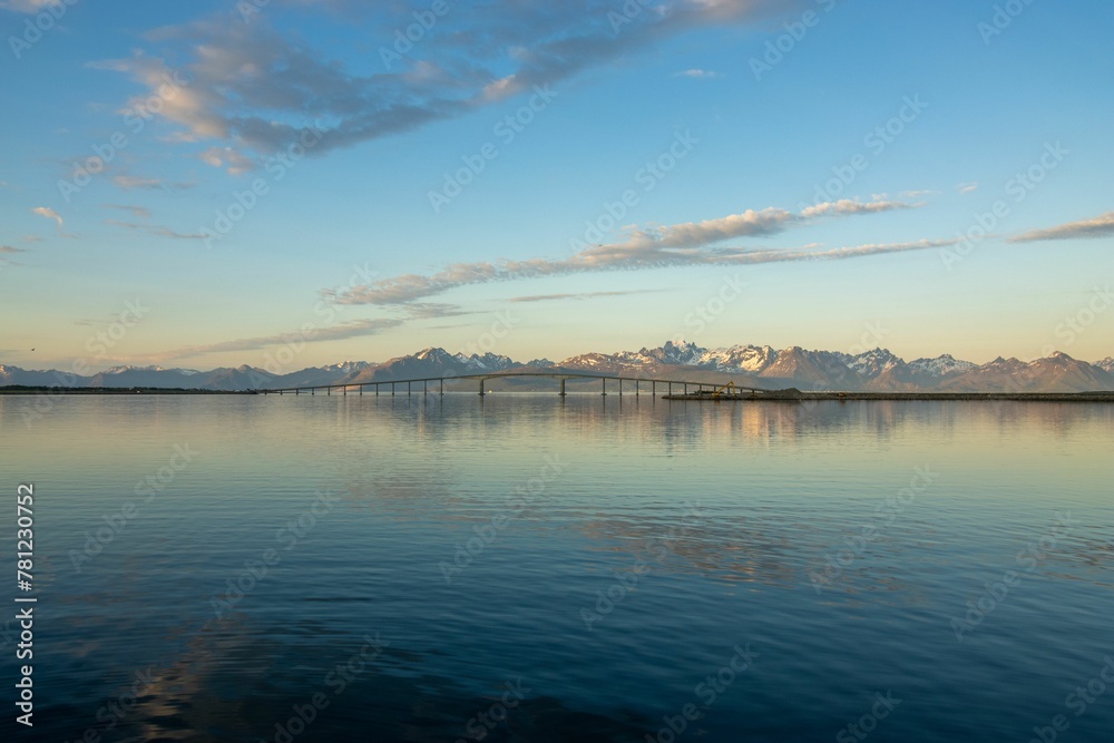 Landscape view of the sea against a mountain backdrop and a blue sky in Northern Norway