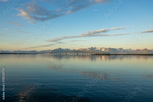 Landscape view of the sea against a mountain backdrop and a blue sky in Northern Norway