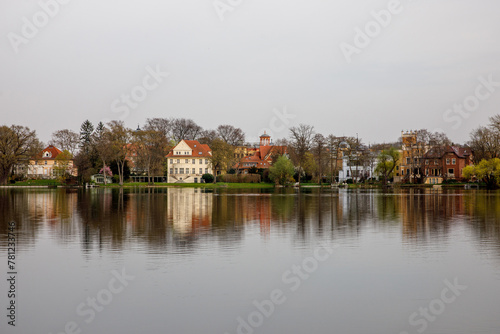 Calm view of lake water and shore with houses in Potsdam, Germany.