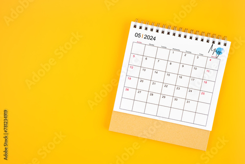 May 2024 desk calendar on yellow color background. © gamjai