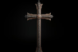 Christian religious metal cross on black background. Christian religious crucifix on black background. Topics related to the Christian religion. Topics related to death. Object of worship and belief.
