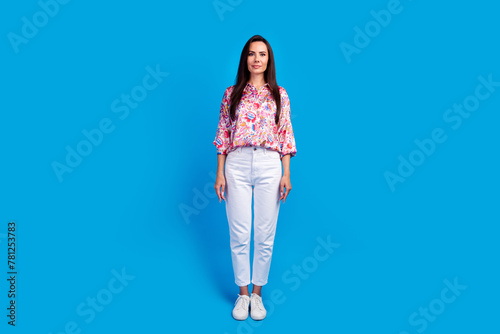 Full length photo of shiny cute lady dressed print blouse walking isolated blue color background
