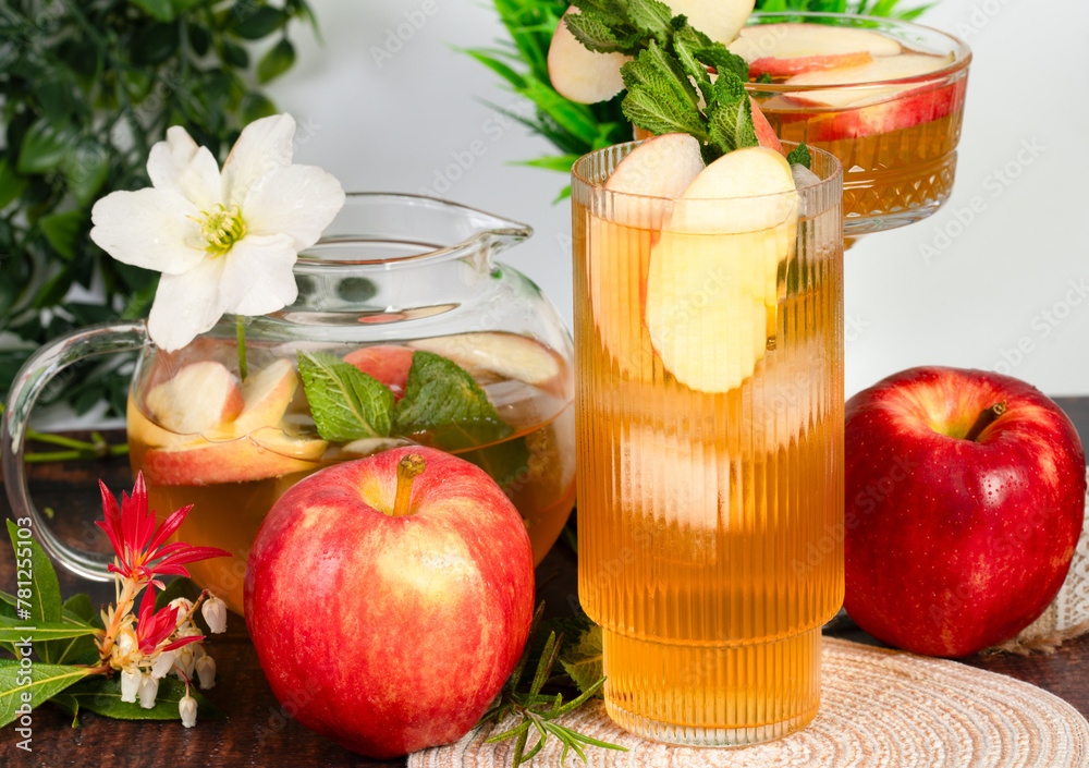 Glass of apple cider surrounded by flowers Glass of apple cider surrounded by flowers