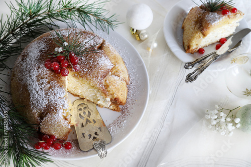 Dolce natalizio italiano. Delizioso pandoro Zuccotto con crema Raffaello. Torta natalizia decorata con ribes rosso. Natale e festività. photo