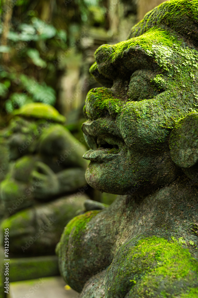 Moss-covered stone carvings in Balinese temple Moss-covered stone carvings in Balinese temple